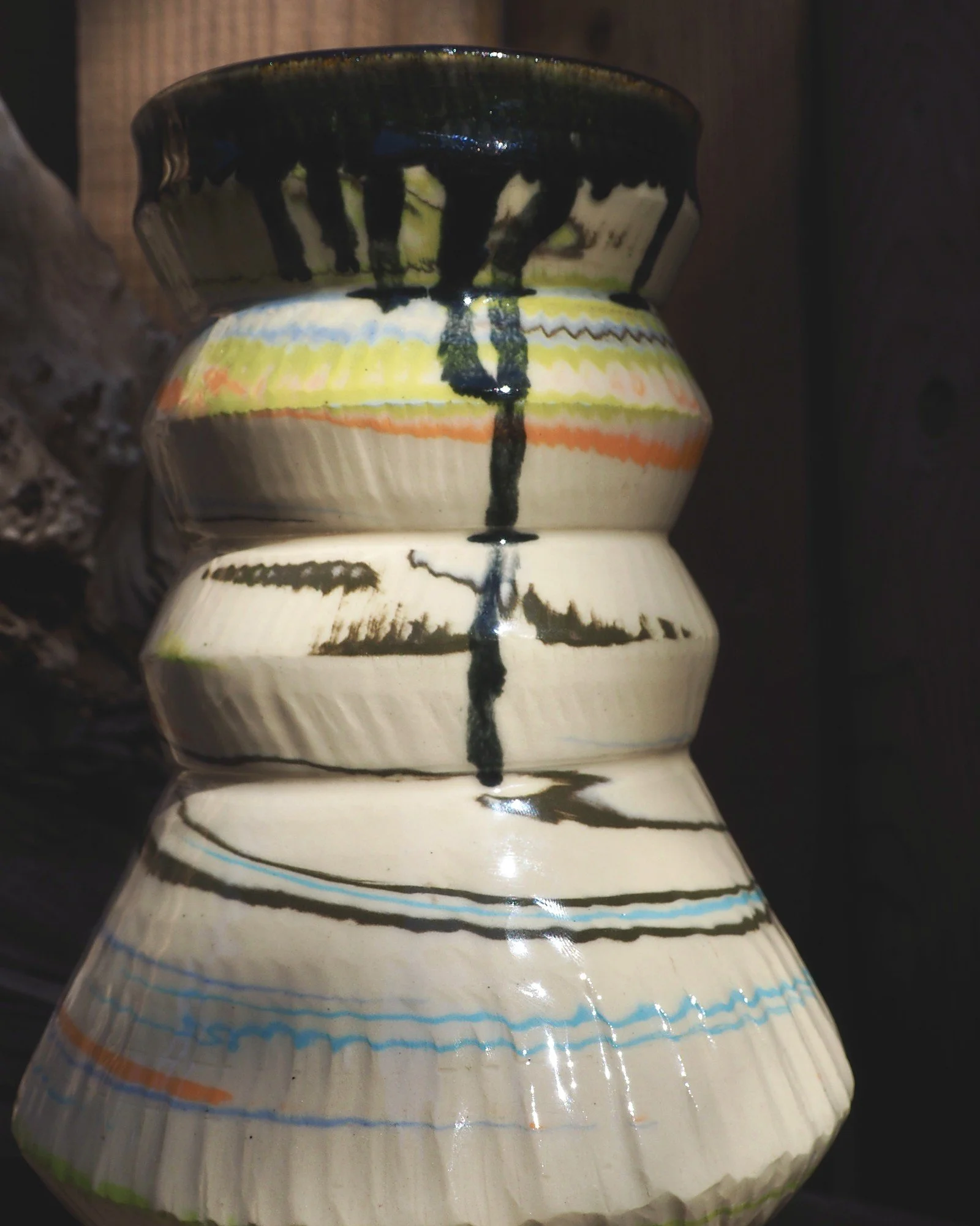 Close-up of colored clay swirl lines on the handmade vase