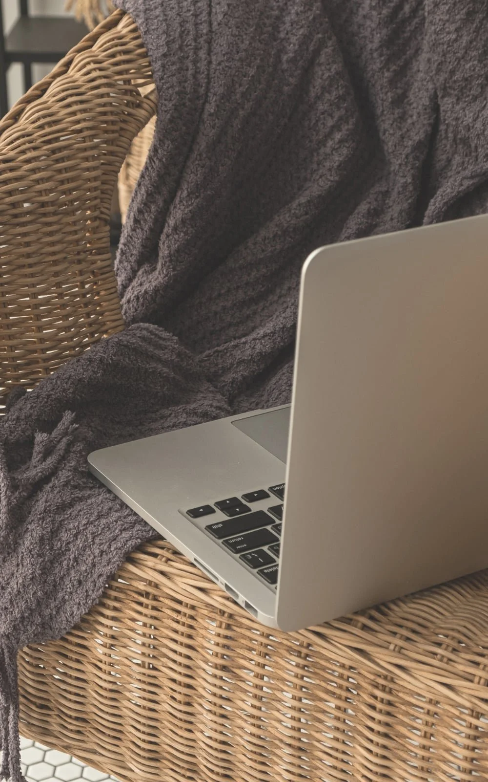 A laptop used for online therapy sessions sits on a chair with a blanket at the office of therapist Gail Gerbig at Seaside Mental Wellness located in Lakewood Ranch.