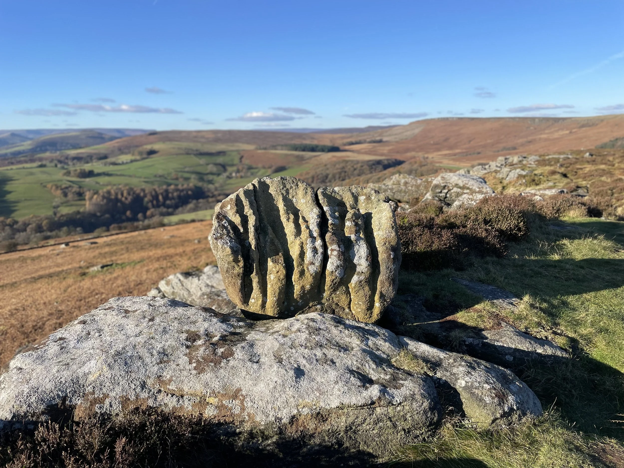 boulder with grooves carved by water representing how life shapes who we become