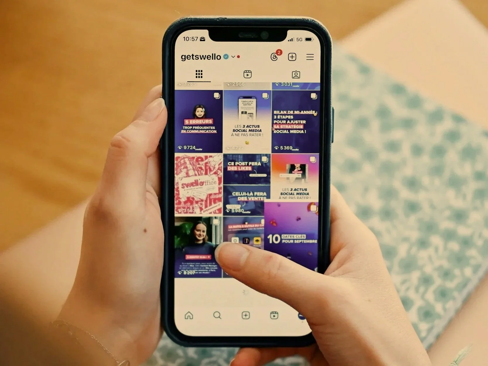 hands holding a mobile phone scrolling through instagram