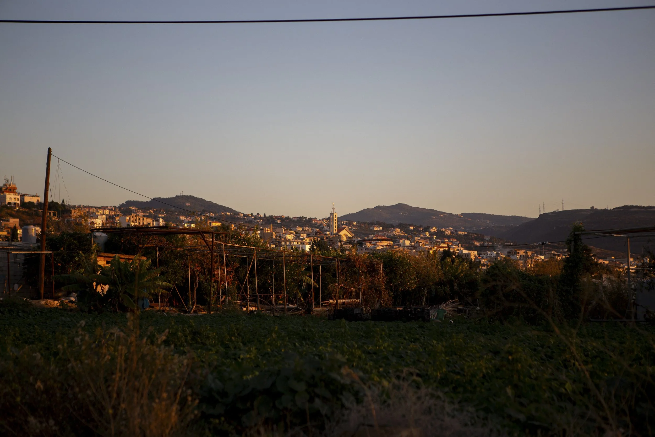A view of Damour from the greenhouses and surrounding farmland. Historically a Christian area of Lebanon, Damour—like much of the country—has seen growing anti-refugee sentiment in recent years, driven by strained infrastructure, economic hardship, w