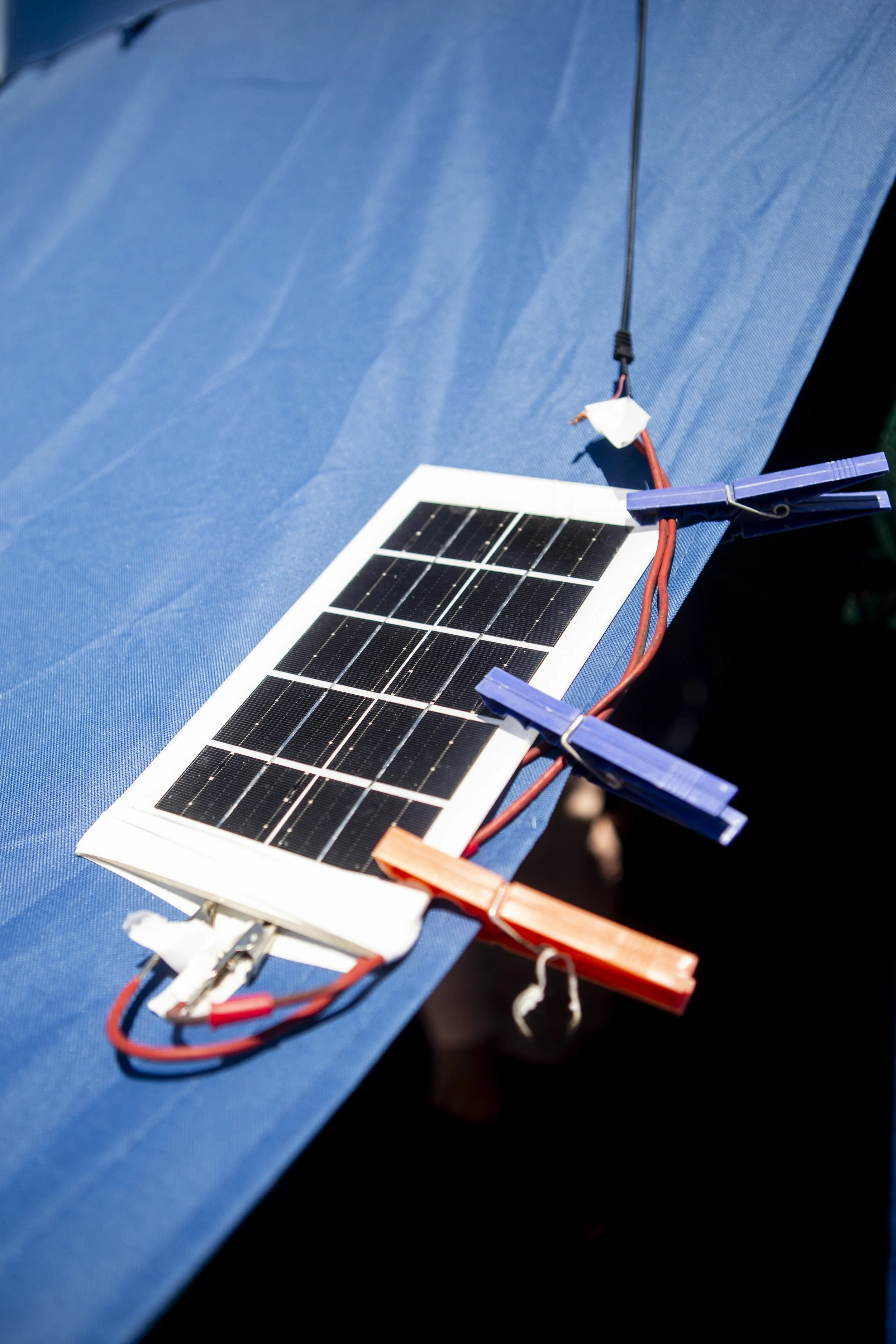 A solar panel above the entrance to Fatme’s tent. The camp, set up by the local municipality, has no electricity — so residents have had to find their own ways to power their lives.