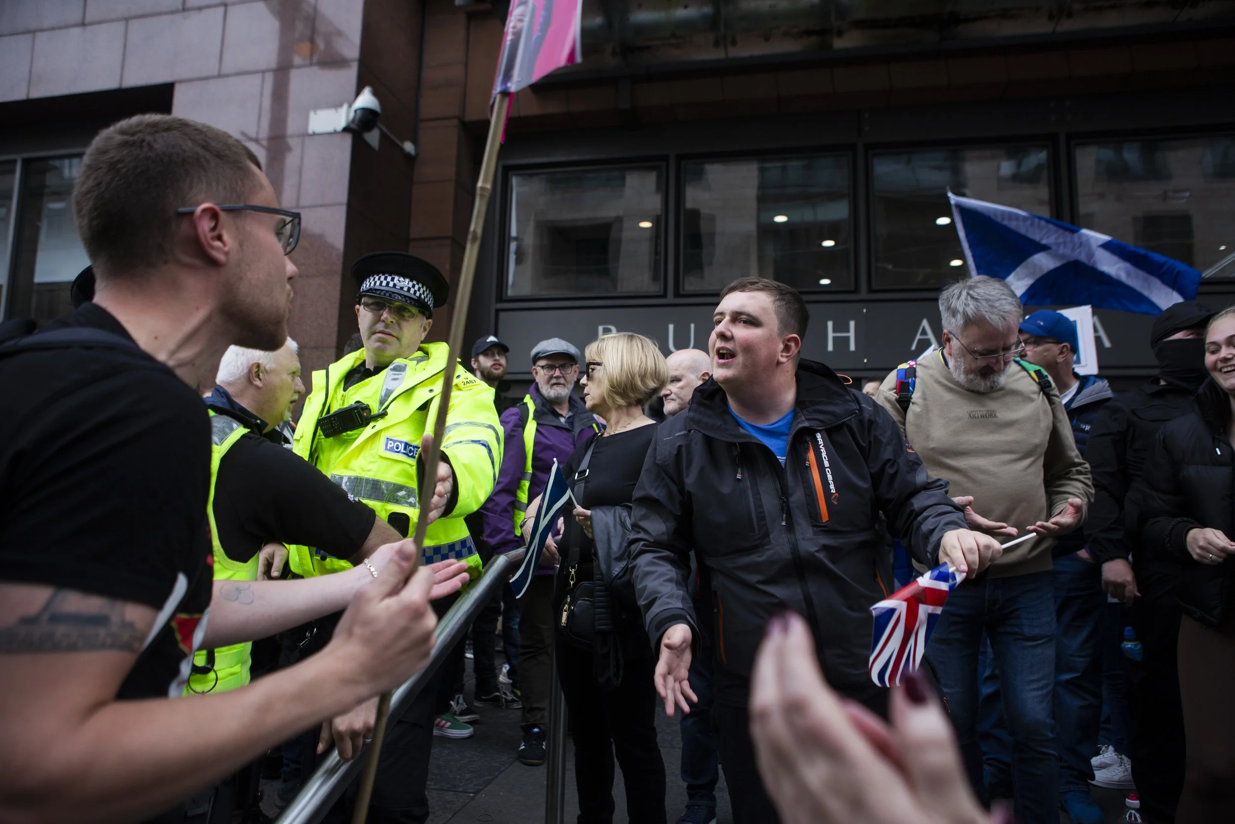 Two protesters engage in a heated debate as police attempt to separate them, May 24, 2025