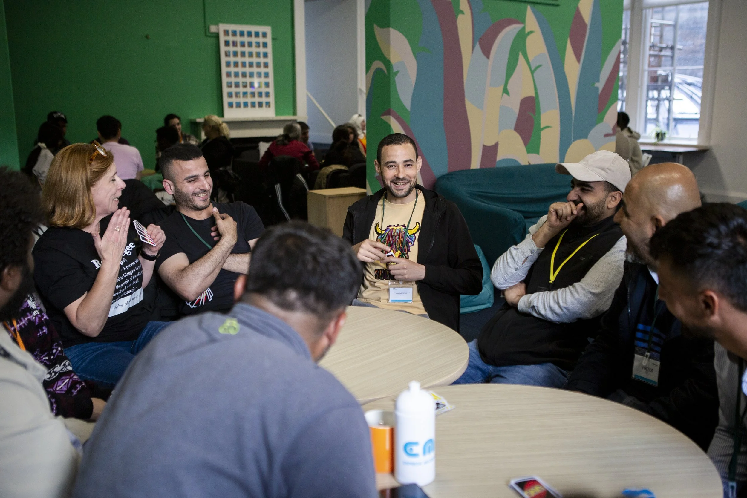 Classes are often informal, with language learning unfolding through conversation, humour, and the relationships formed between locals and newcomers. In this class they play the card game UNO together.