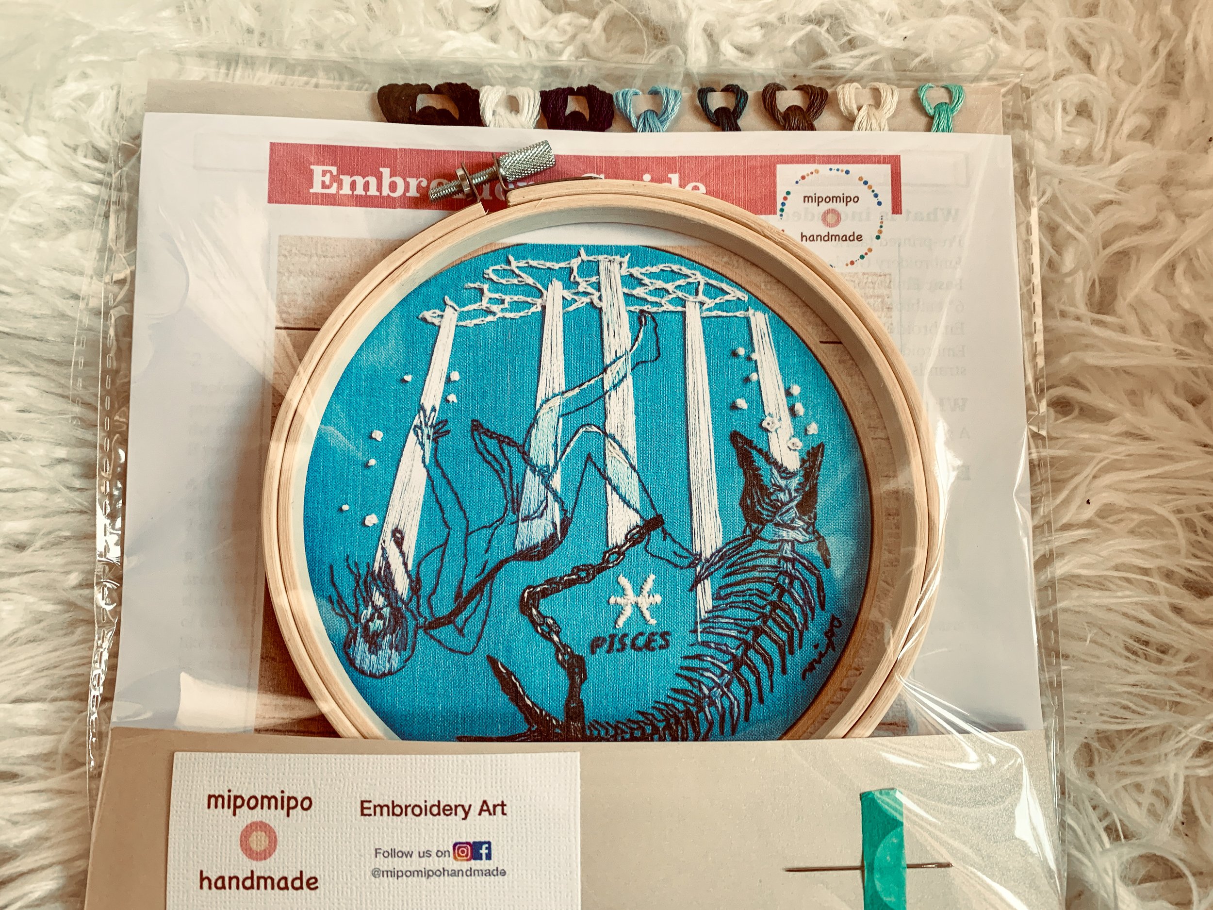 Gift-wrapped Pisces embroidery kit from Mipomipo Handmade with natural packaging.