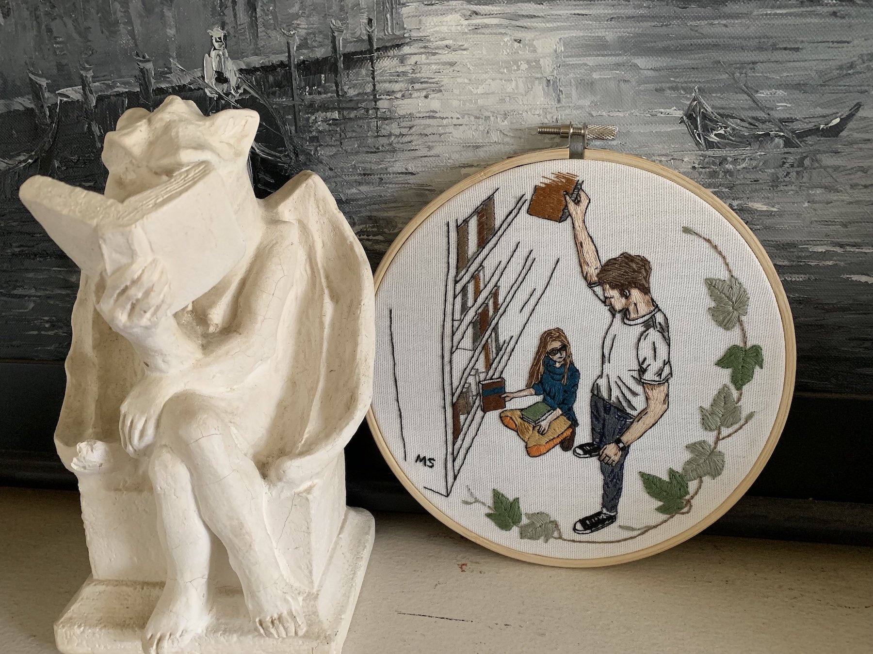 LIBRARY -embroidery hoop art displayed next a gargoyl  .jpeg
