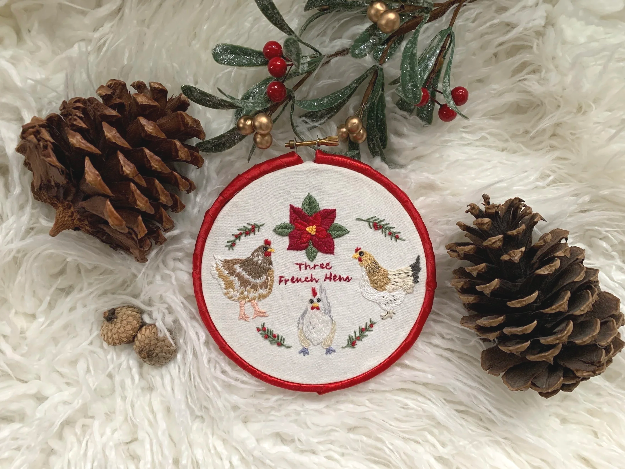 Three+French+Hens+holiday+embroidery+with+red+ribbon+wrapped+hoop.png