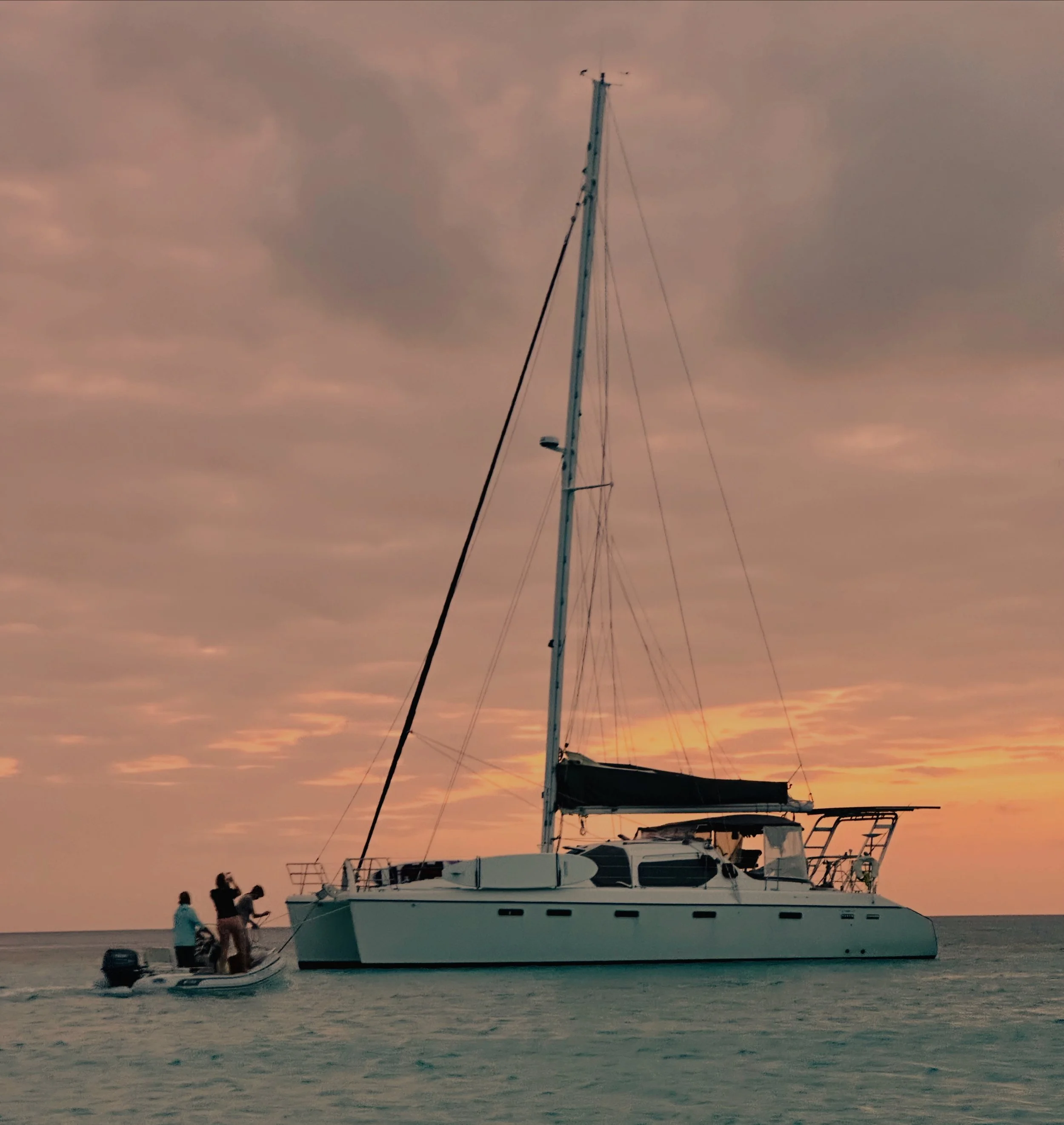 Sailing Catamaran Charter Boat Vacation in Bahamas with sunset backdrop