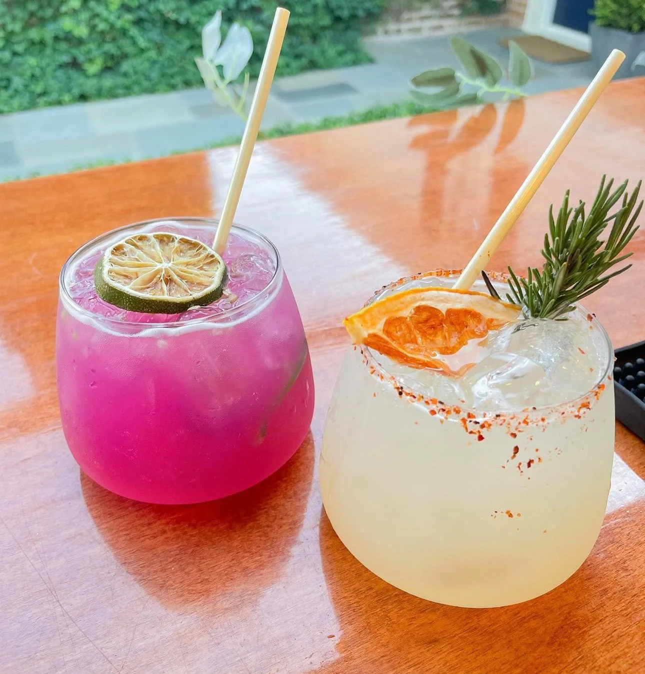 Scratch made Spicy margarita and dragon fruit margarita in tossware cups ready for a party