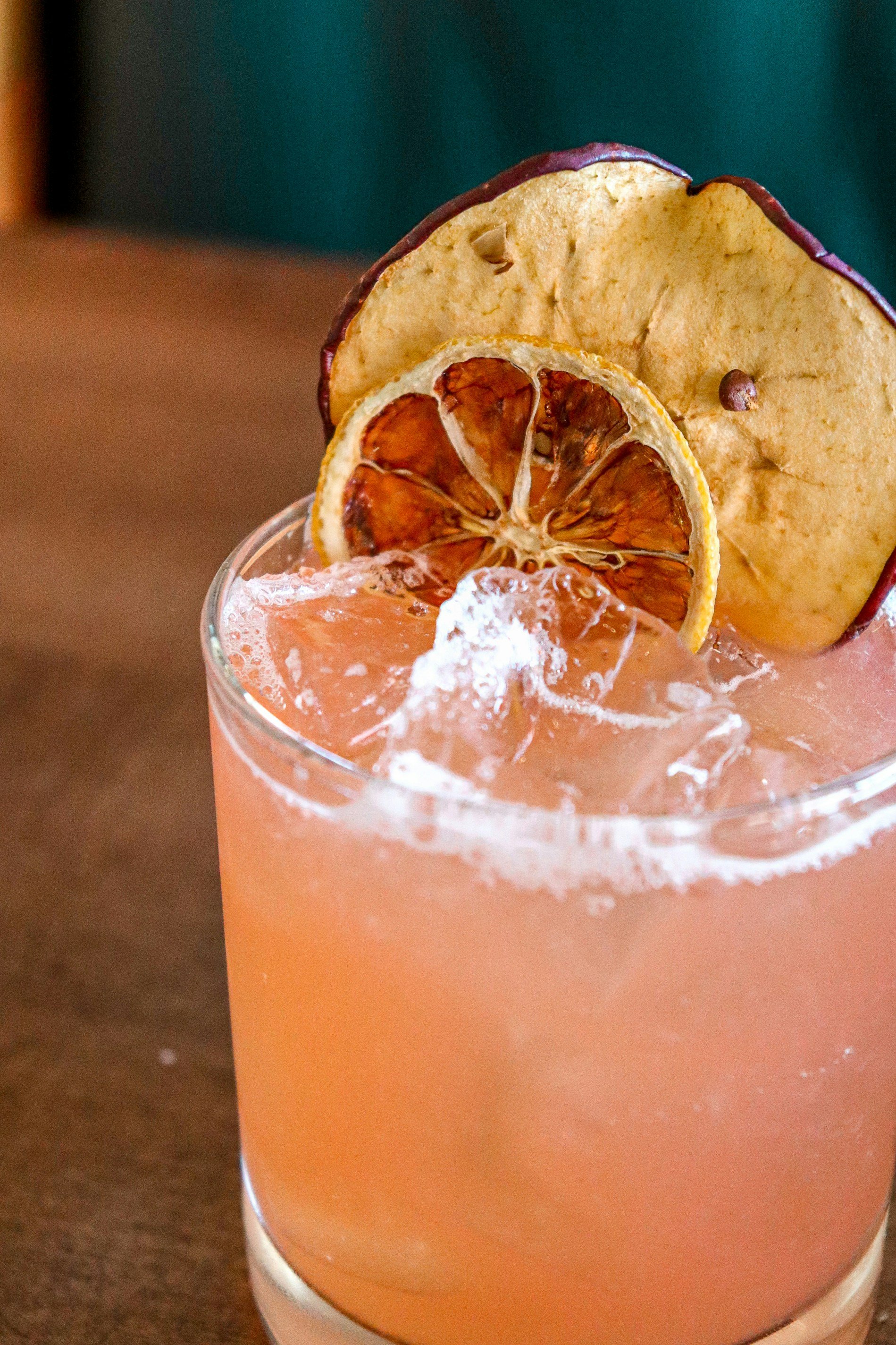 Craft garden-to-glass cocktail with dried citrus garnish