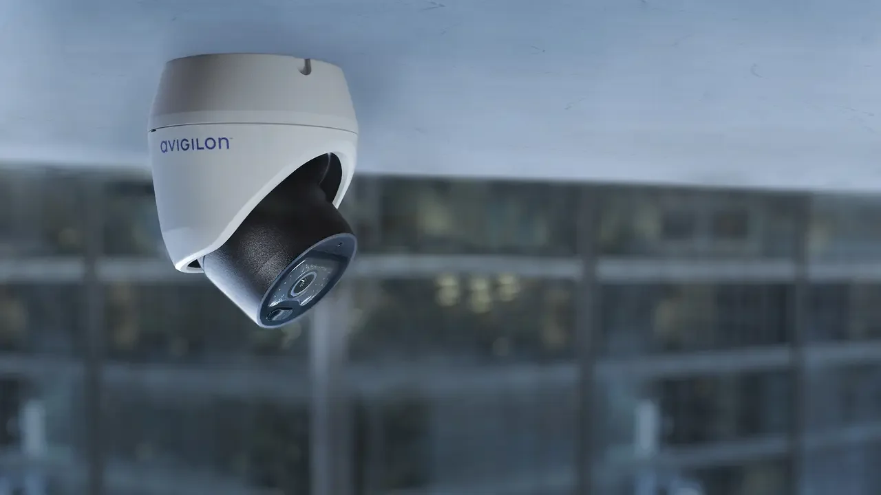 Ceiling-mounted security camera monitoring a large facility for surveillance and safety coverage