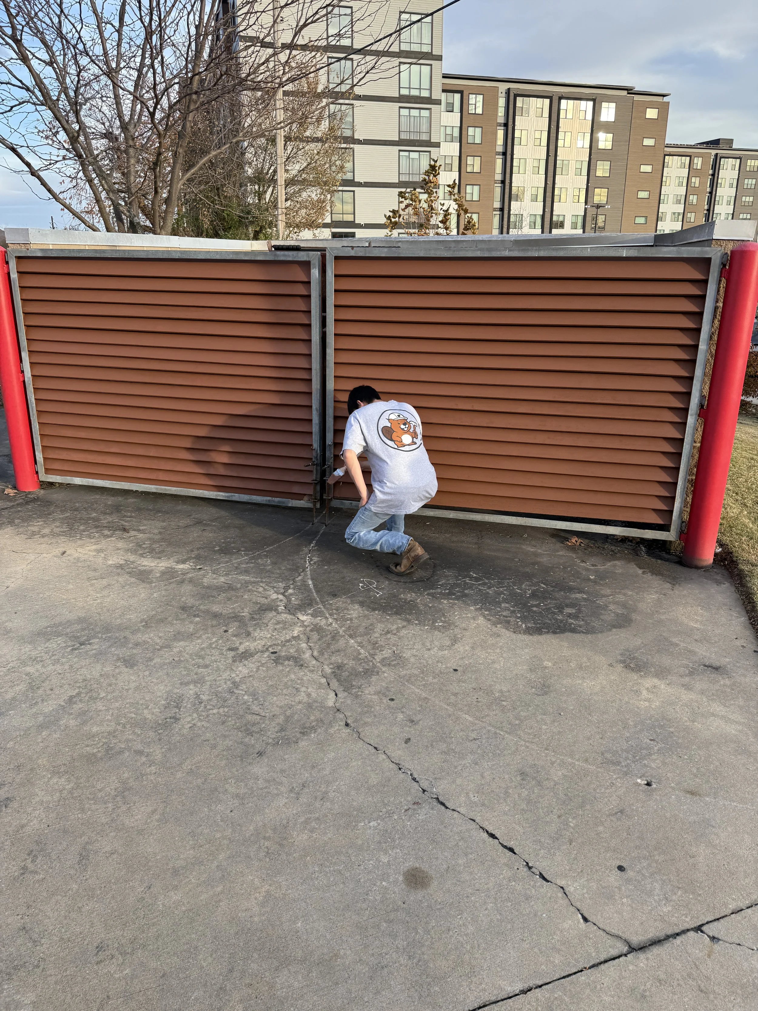 A team member repairing a gate