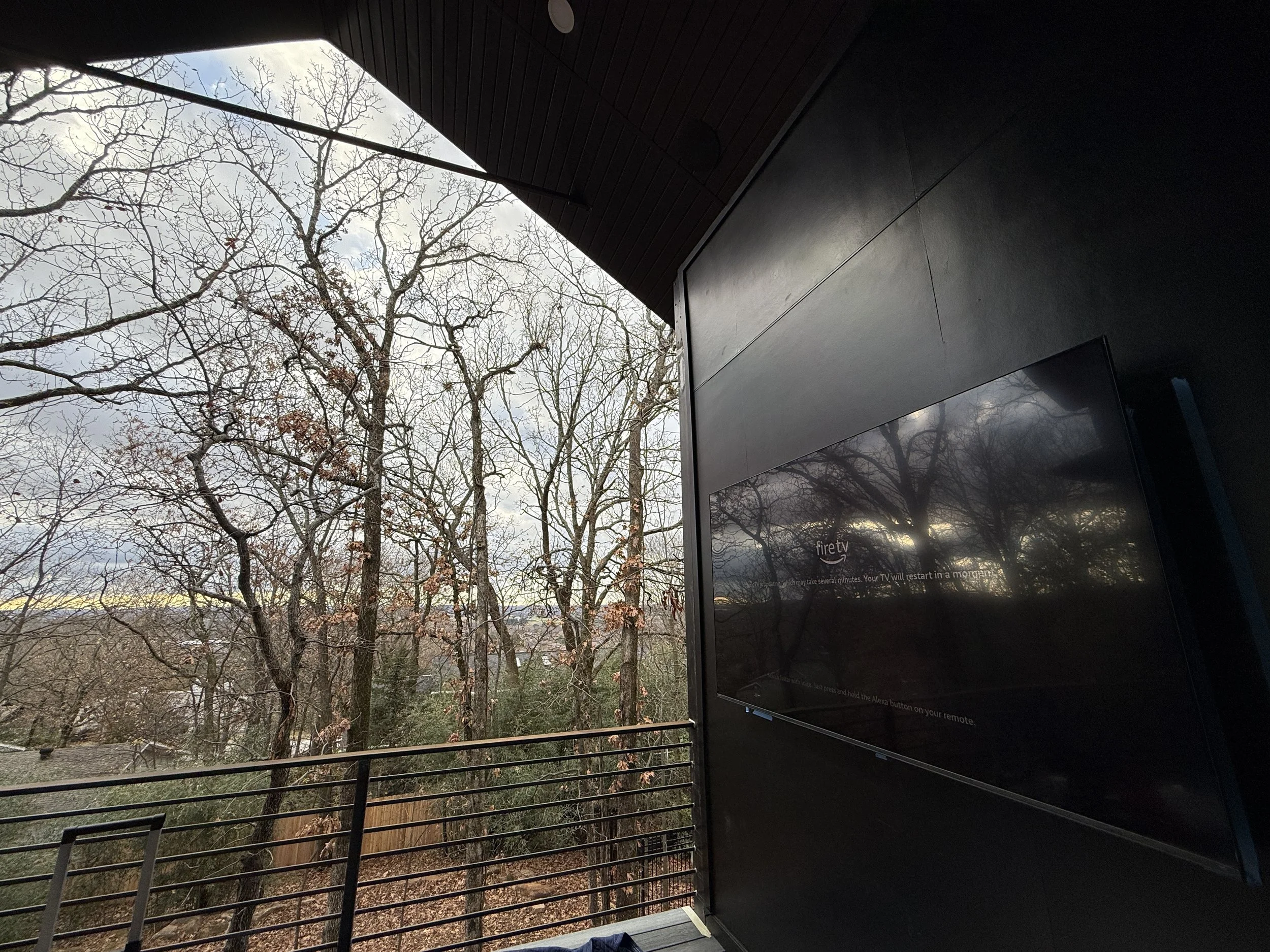 An 85 inch tv installed on a deck