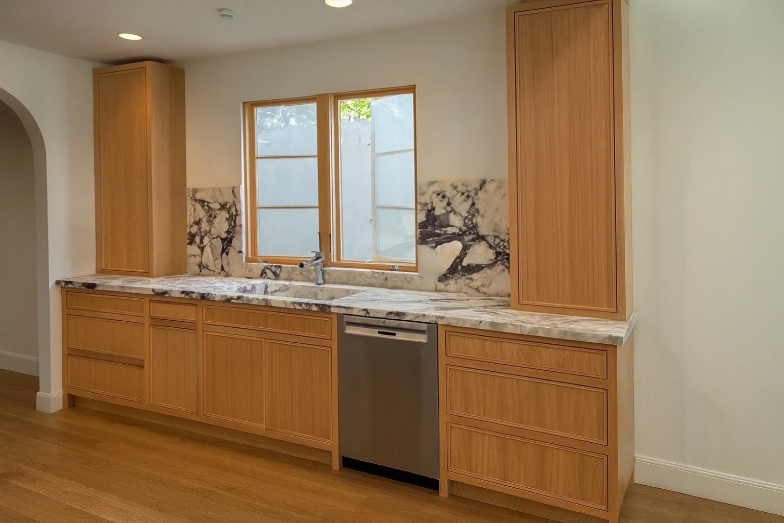 Modern oak kitchen cabinets with marble island and slim shaker doors