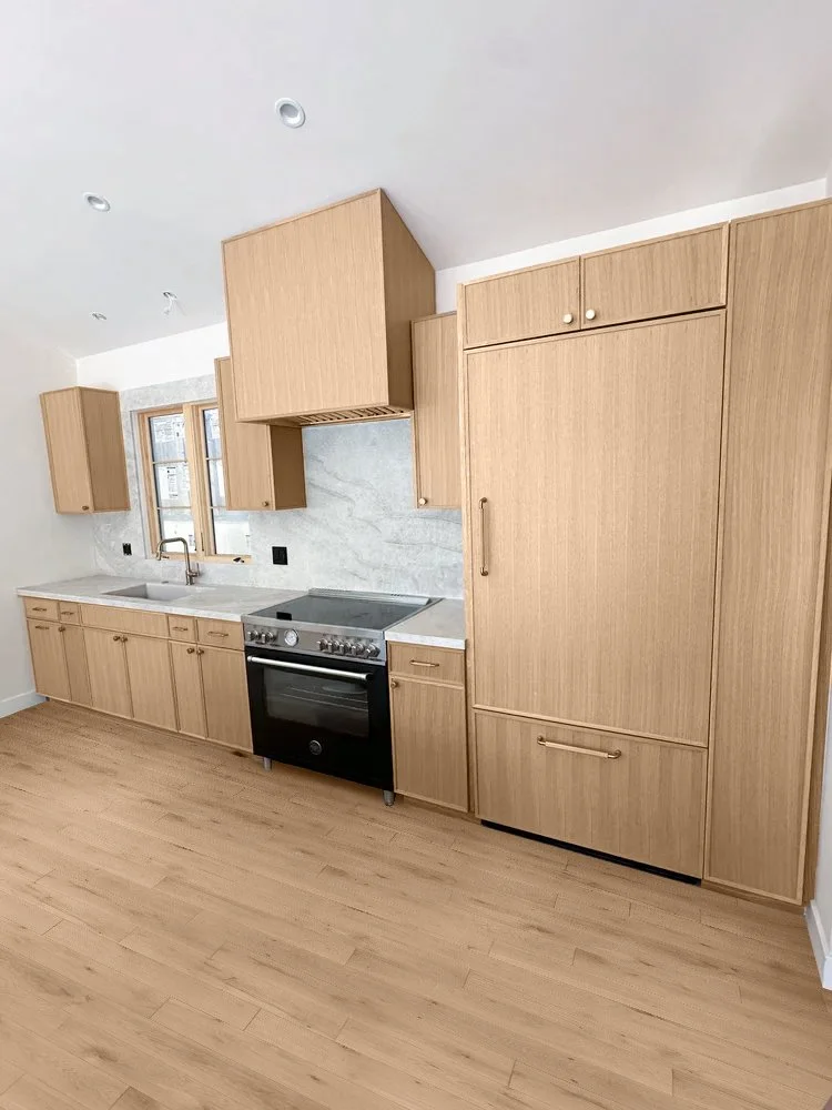 Modern oak kitchen cabinets with marble island and slim shaker doors