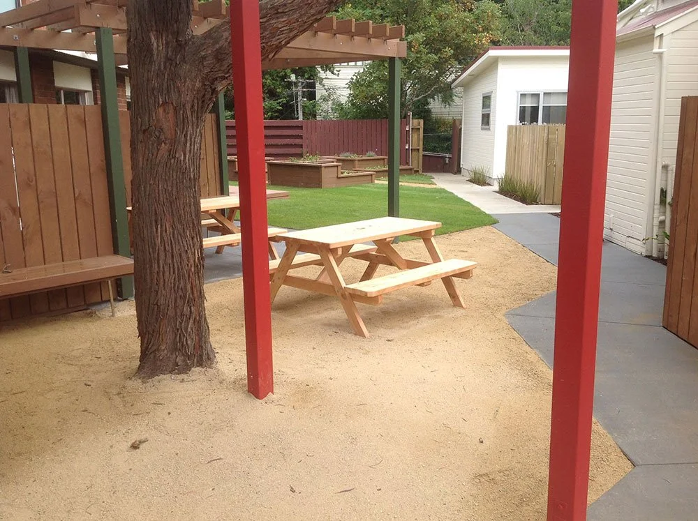 7-Vic-Uni-Halls-Outdoor-Area---Timber-fencing-and-seating,-pergolas,-coloured-concrete,-limestone,-timber-planters-and-lawn.jpg