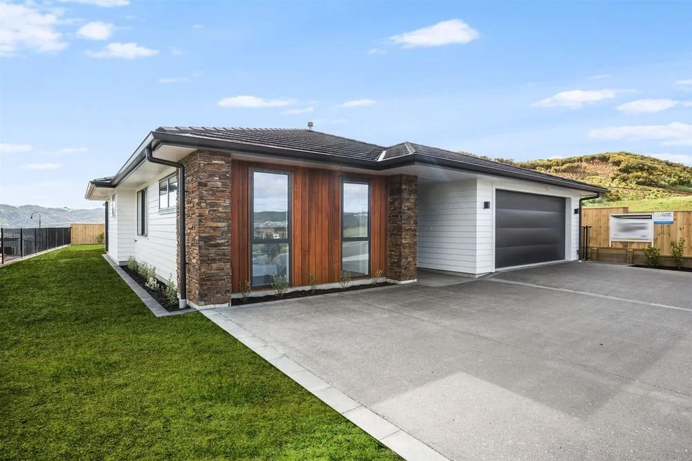 5 Aotea - Full Landscape, Exposed Aggregate Driveway with paved bordered edging and grids, Paved Entranceway, Block Retaining, Aluminium Fencing, Lawn, Planting.jpeg