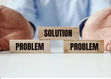 Two problem blocks on a table with a solution block placed above one problem and between two problems.