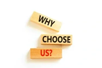Three Scrabble tiles spelling out 'WHY CHOOSE US?'