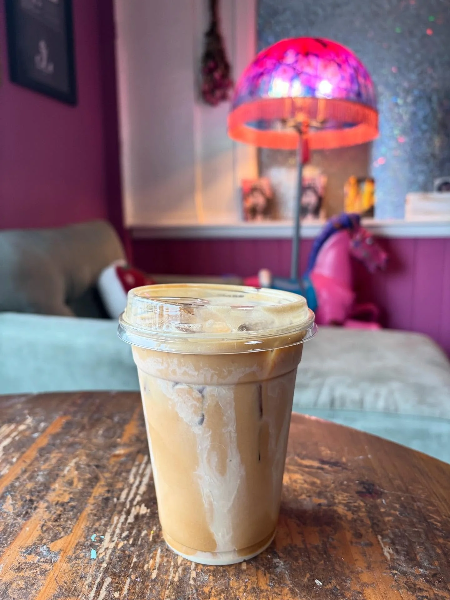 A cafe latte in a to-go cup on one of the tables inside Pink Pony Cafe in Port Angeles