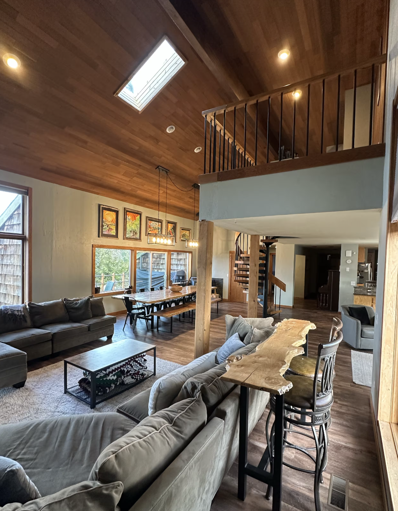 The interior of a cabin rental at Deer Park, Port Angeles. Featuring rustic decor and a spacious living room with wooden cielings.