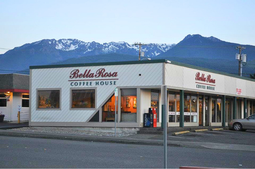 Exterior of Bella Rosa Coffee House with a mountain range in the background