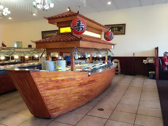 A buffet table designed to look like a Japanese boat with a roof and lantern decorations