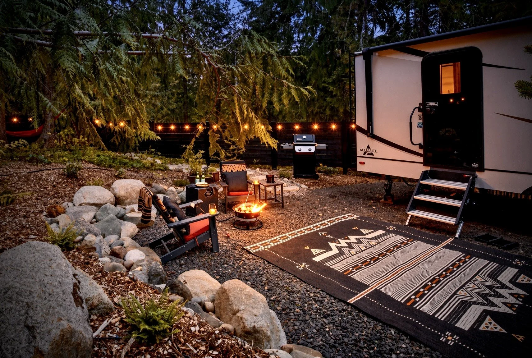 Camp Sugi, an RV Air Bnb located in the woods of Port Angeles, WA, featuring cozy firepit seating outside.