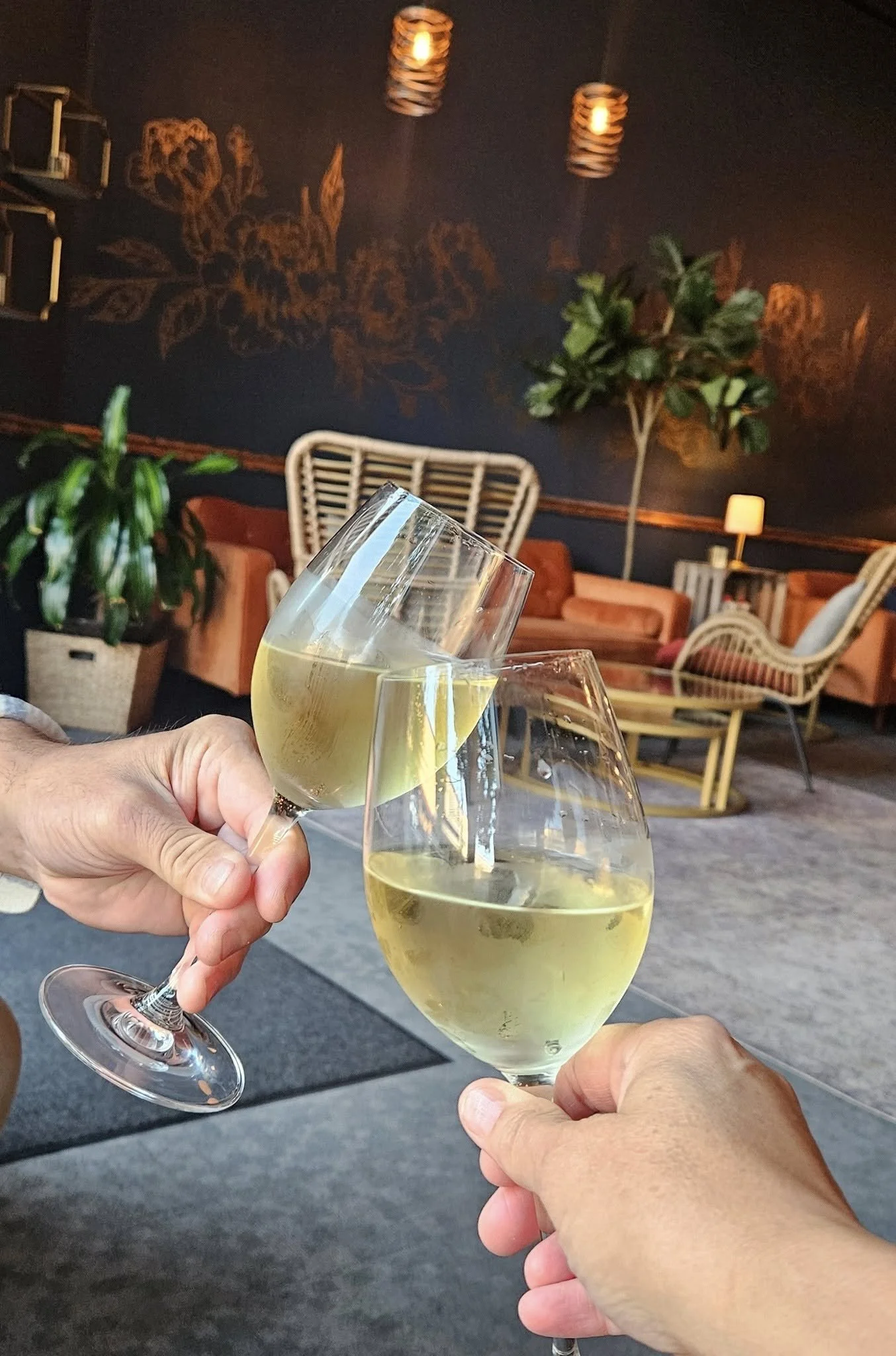 Two people toasting wine at First Street Haven