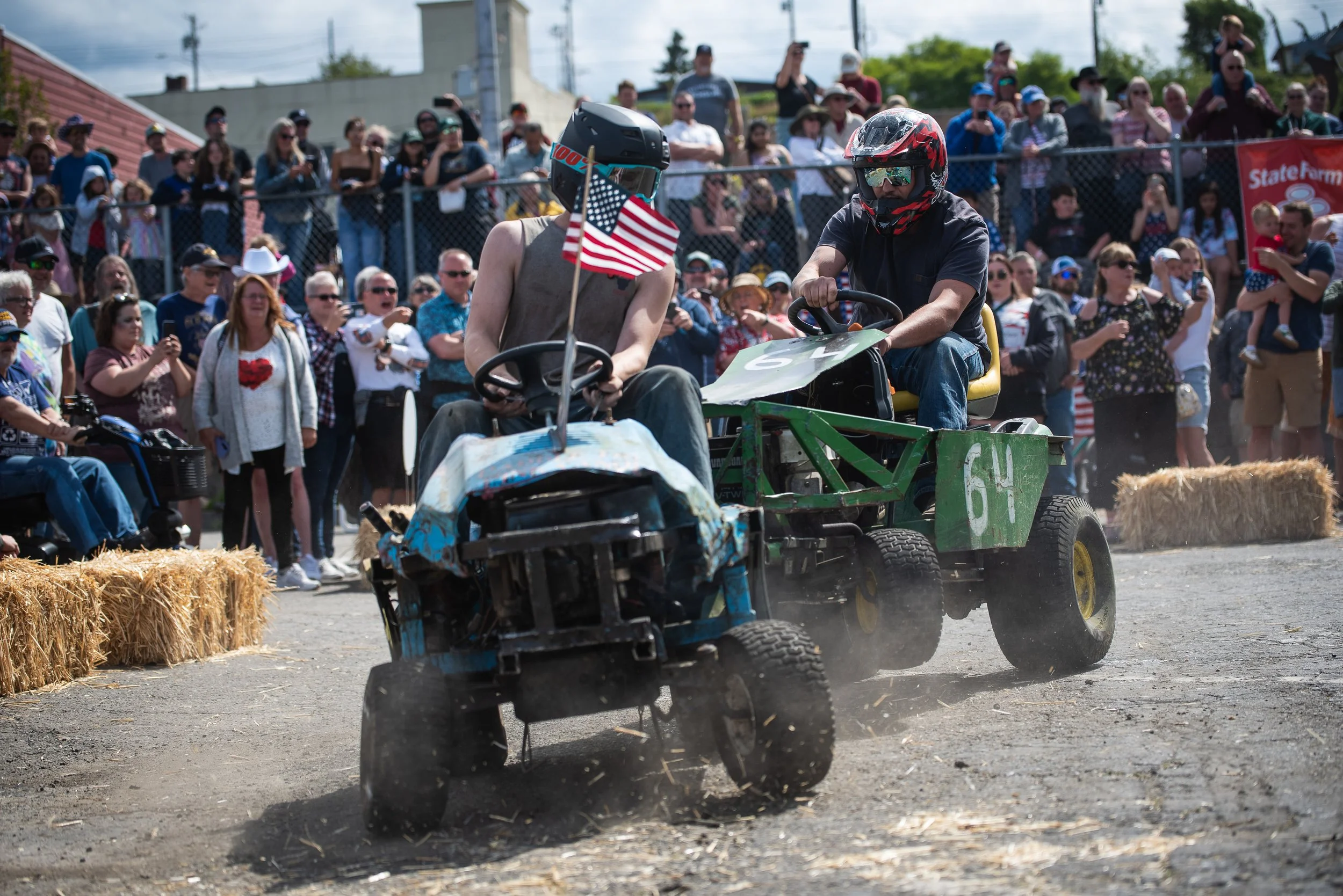 Two lawn mower riders clashing into each other during the Fourth of July Lawn Mower Derby