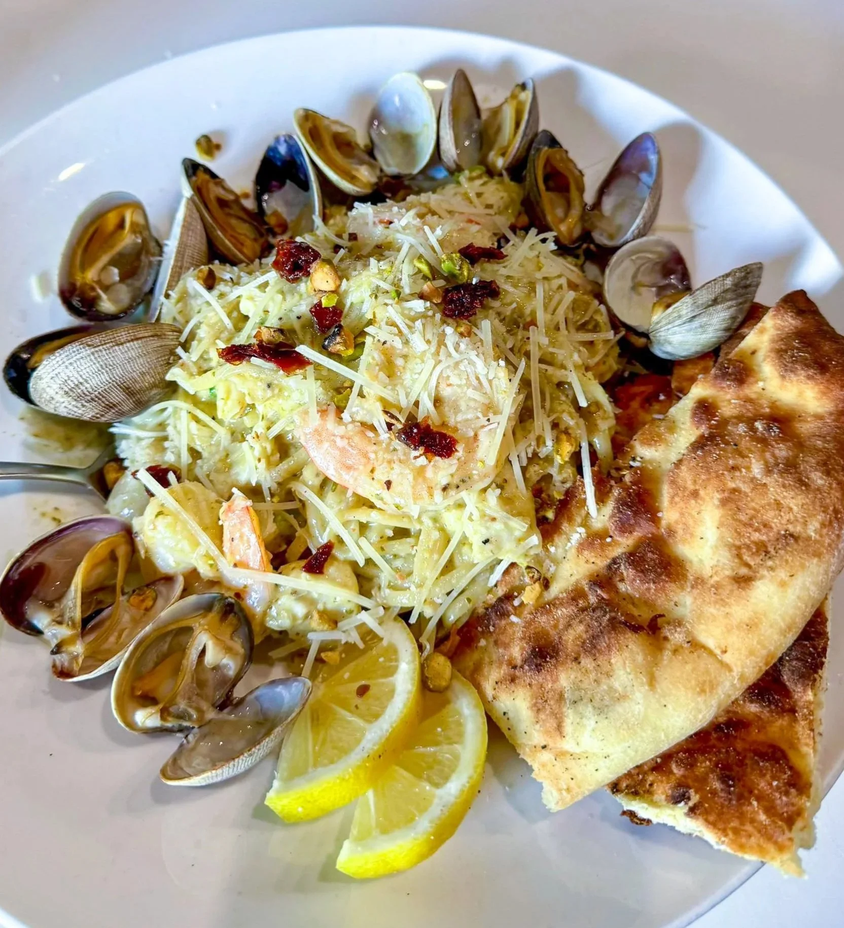 A plate of shrimp and seafood on rice at 929 Woodfire Grill in Port Angeles
