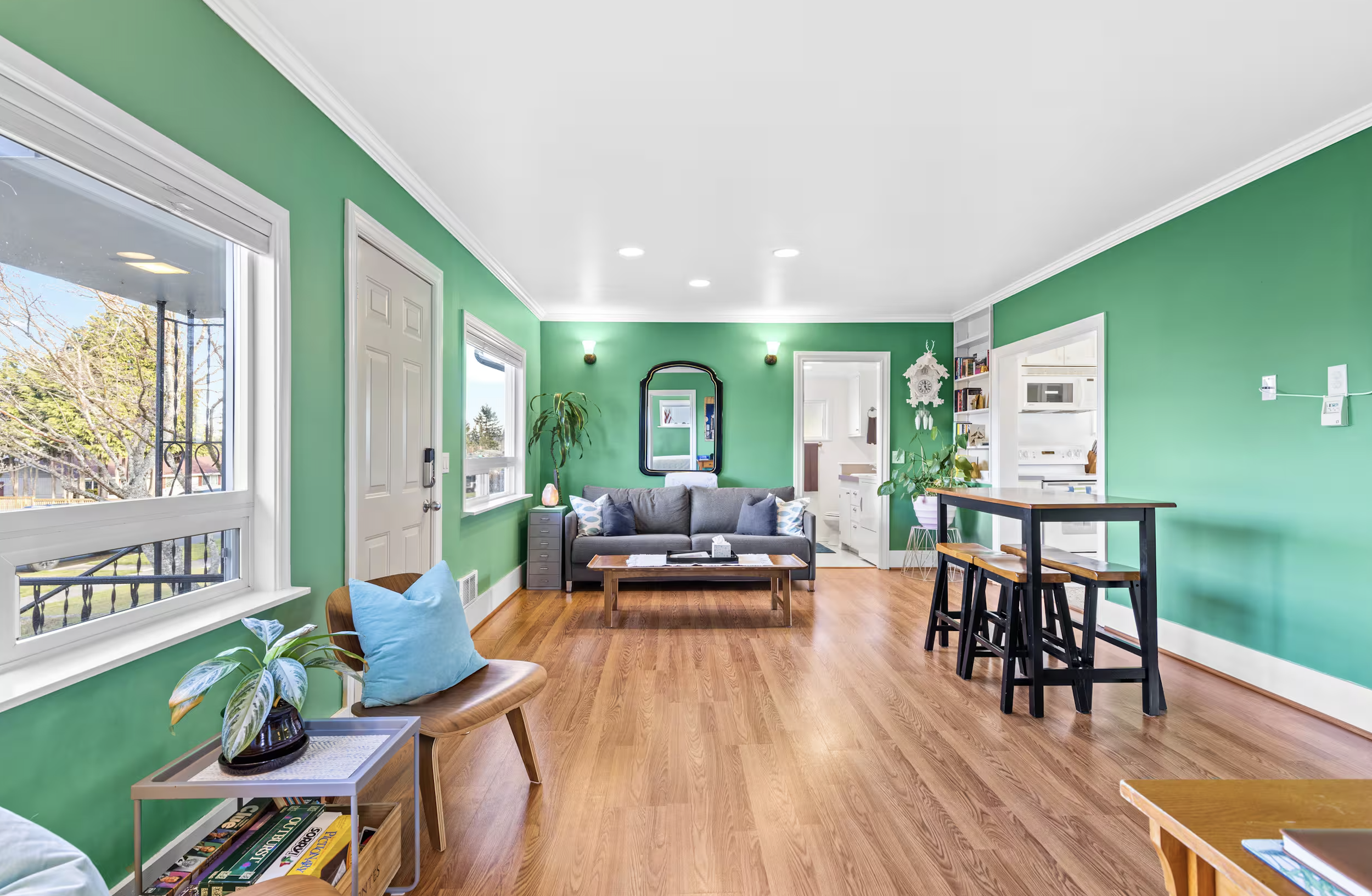 A modern Air BnB living room with bright green colored walls