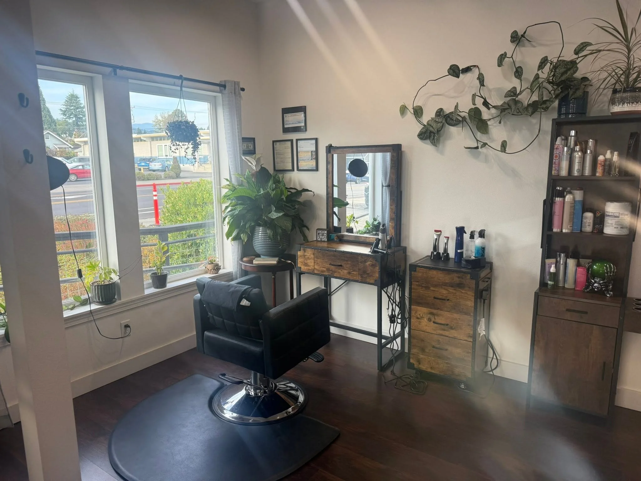 A hair salon with modern rustic decor and plants.