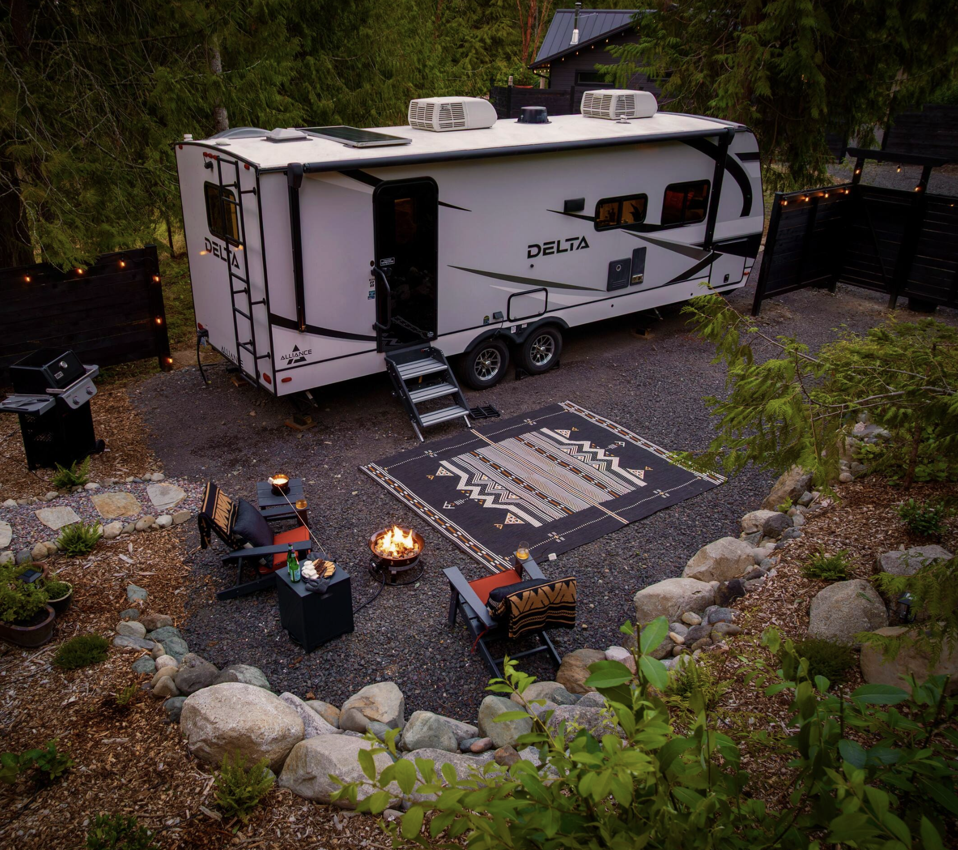 Camp Sugi, an RV Air Bnb located in the woods of Port Angeles, WA, featuring cozy firepit seating outside.