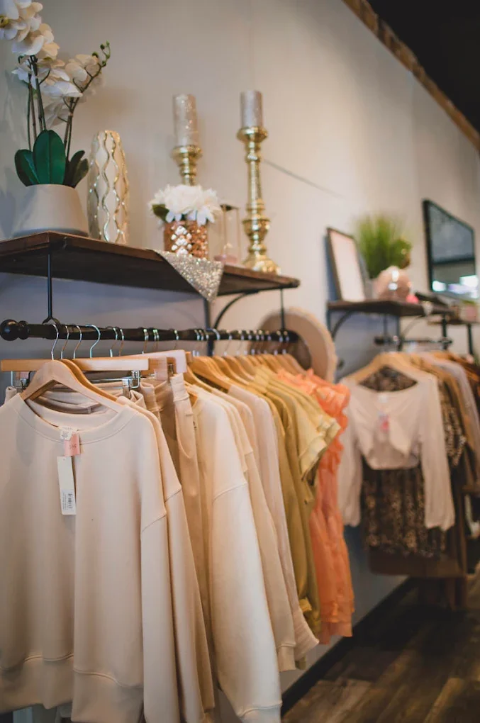 Clothes displayed on hanging displays with sparkly decor inside the shop.