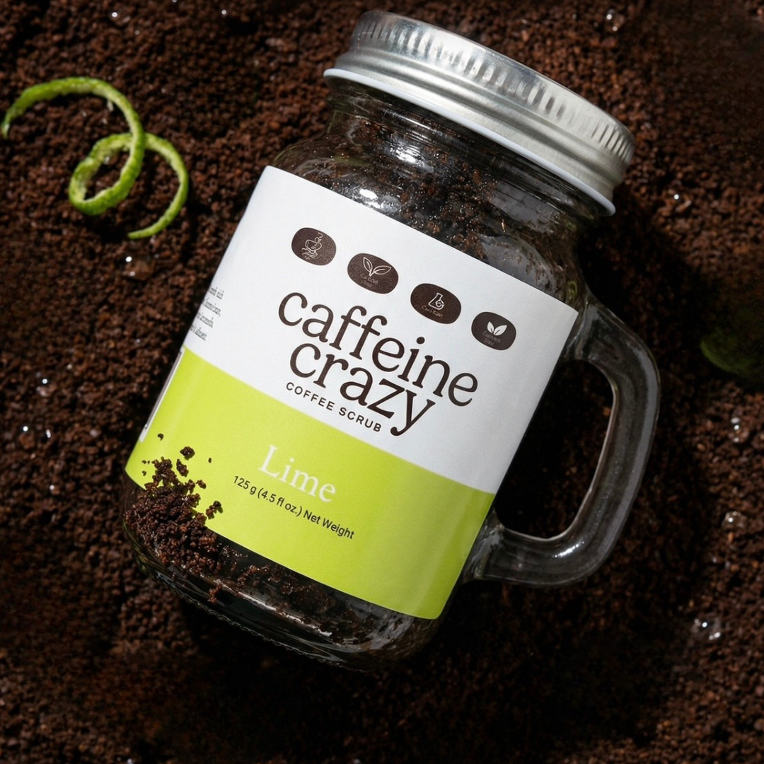 Lime caffeine crazy coffee scrub laying in coffee scrub with a fresh lime zest to the side of the product.