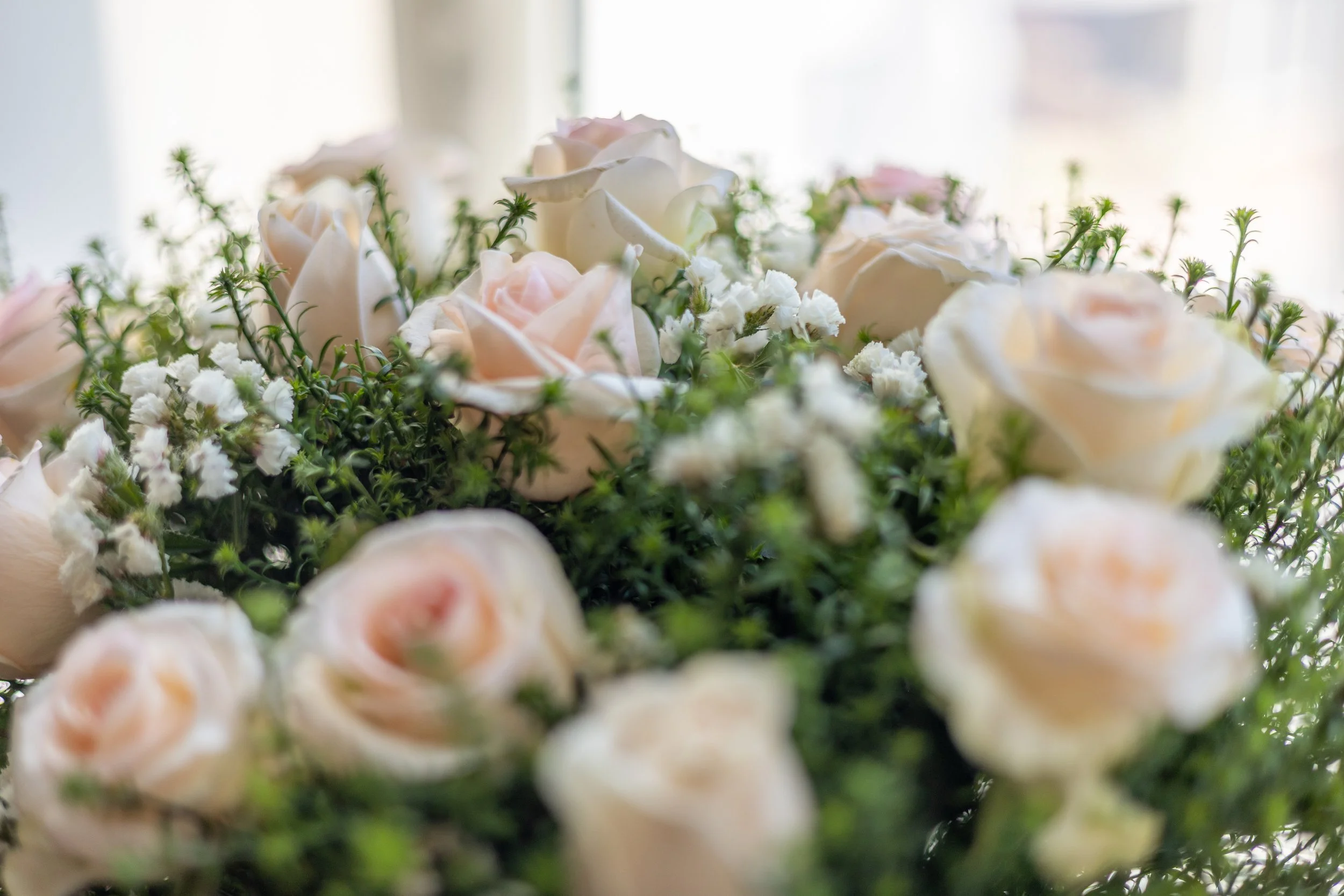 Close-up of a bouquet of white and blush pink roses