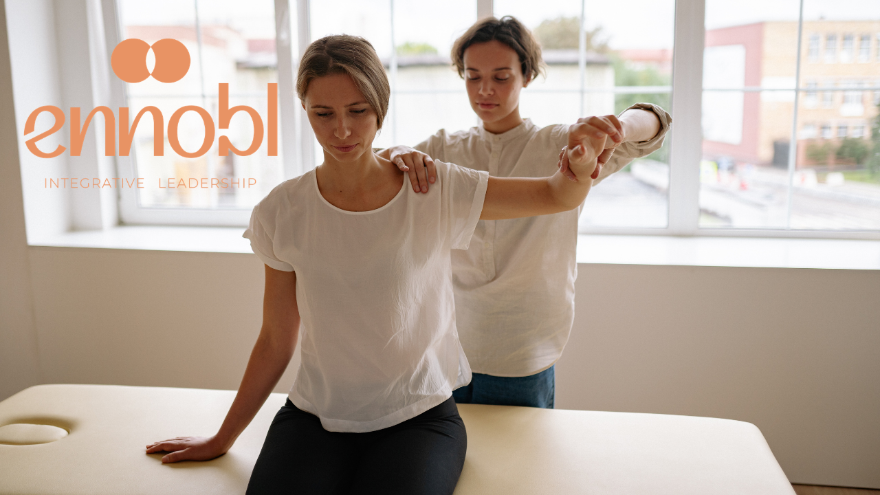 Physical Therapist helping a woman client with her arm and shoulder.