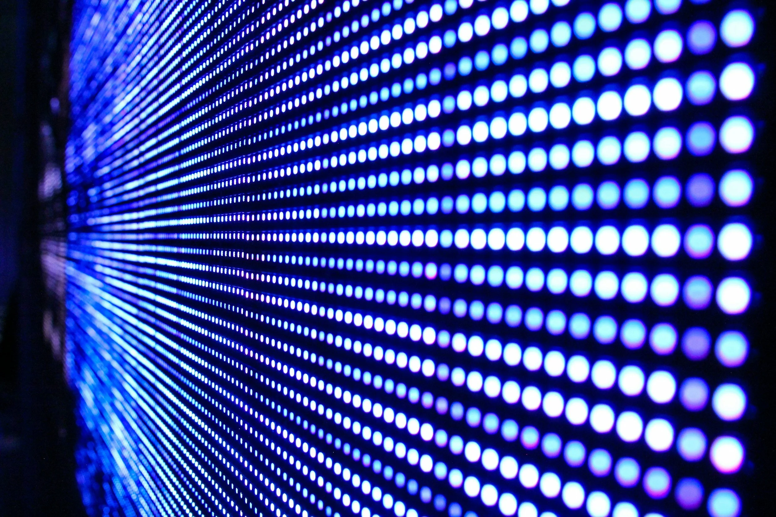 Close-up of LED light panel displaying blue and purple dotted patterns.