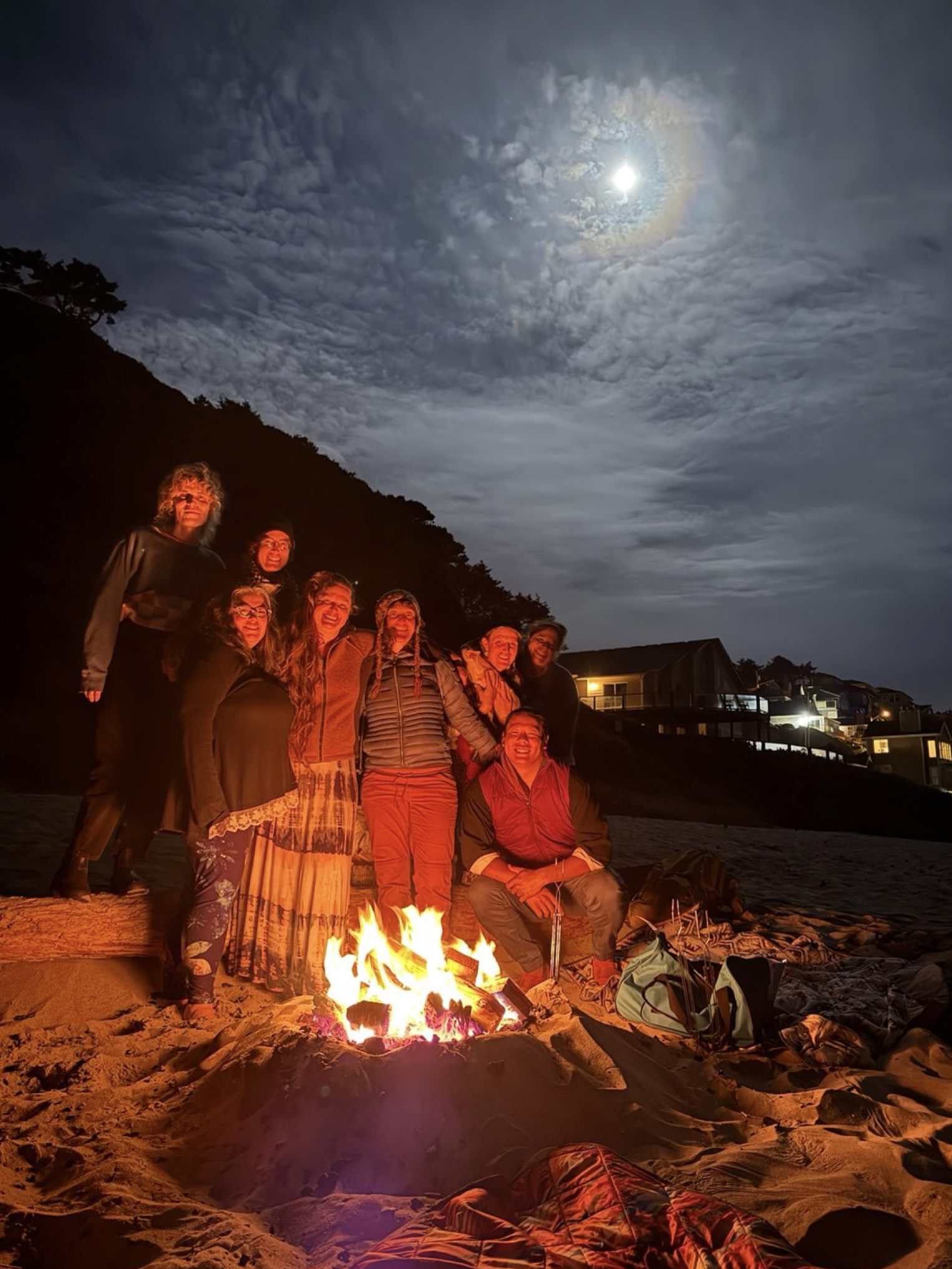 A group of TendWell team members enjoying a campfire at the Oregon coast.