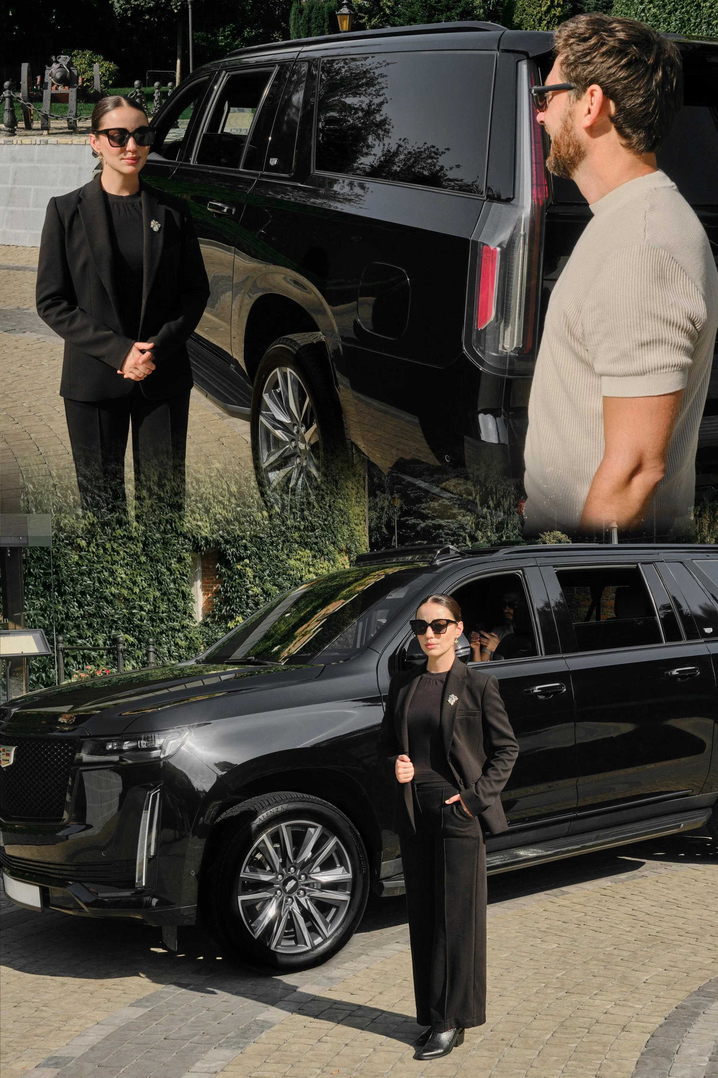 A woman with dark sunglasses and a black suit standing next to a black luxury SUV, with a man in a beige shirt and glasses standing nearby.
