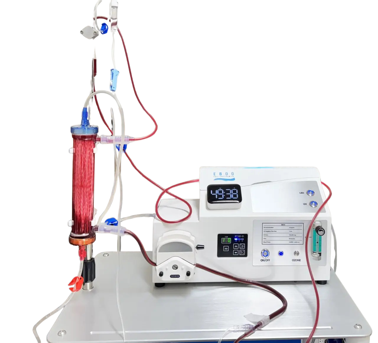 Laboratory machine with a digital display, connected tubing, and a red liquid-filled cylinder, used in water purification or filtration processes.