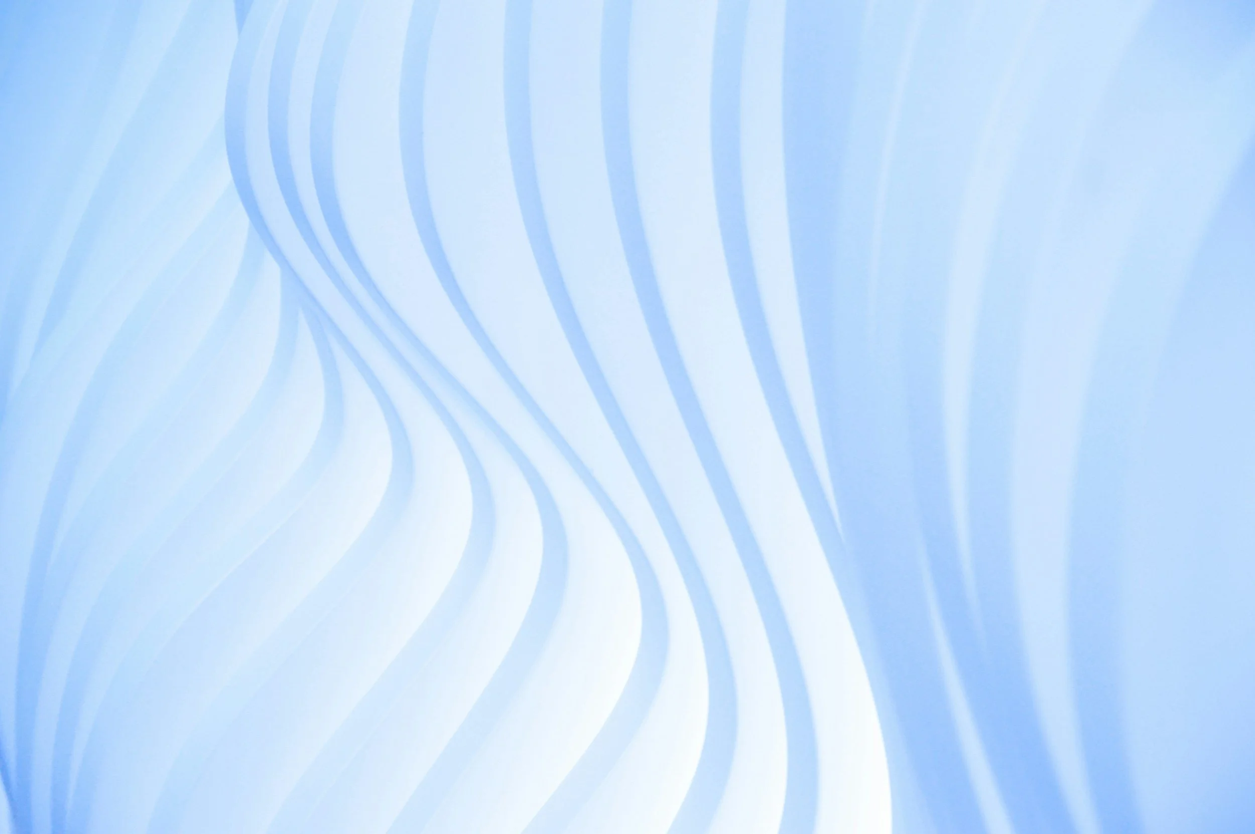 Light blue background with abstract white and darker blue flowing curved lines, creating a pattern..