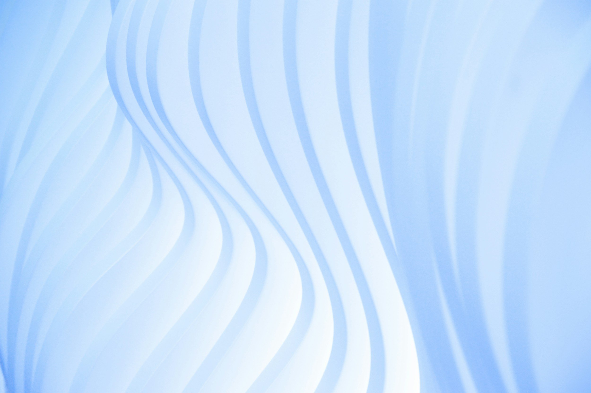 Abstract background with flowing white and light blue curved lines