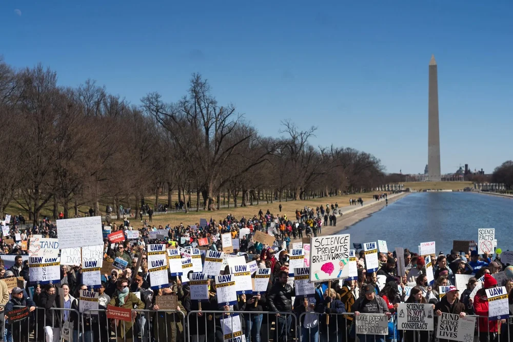 A large science-funding protest near the Reflecting Pool and Washington Monument