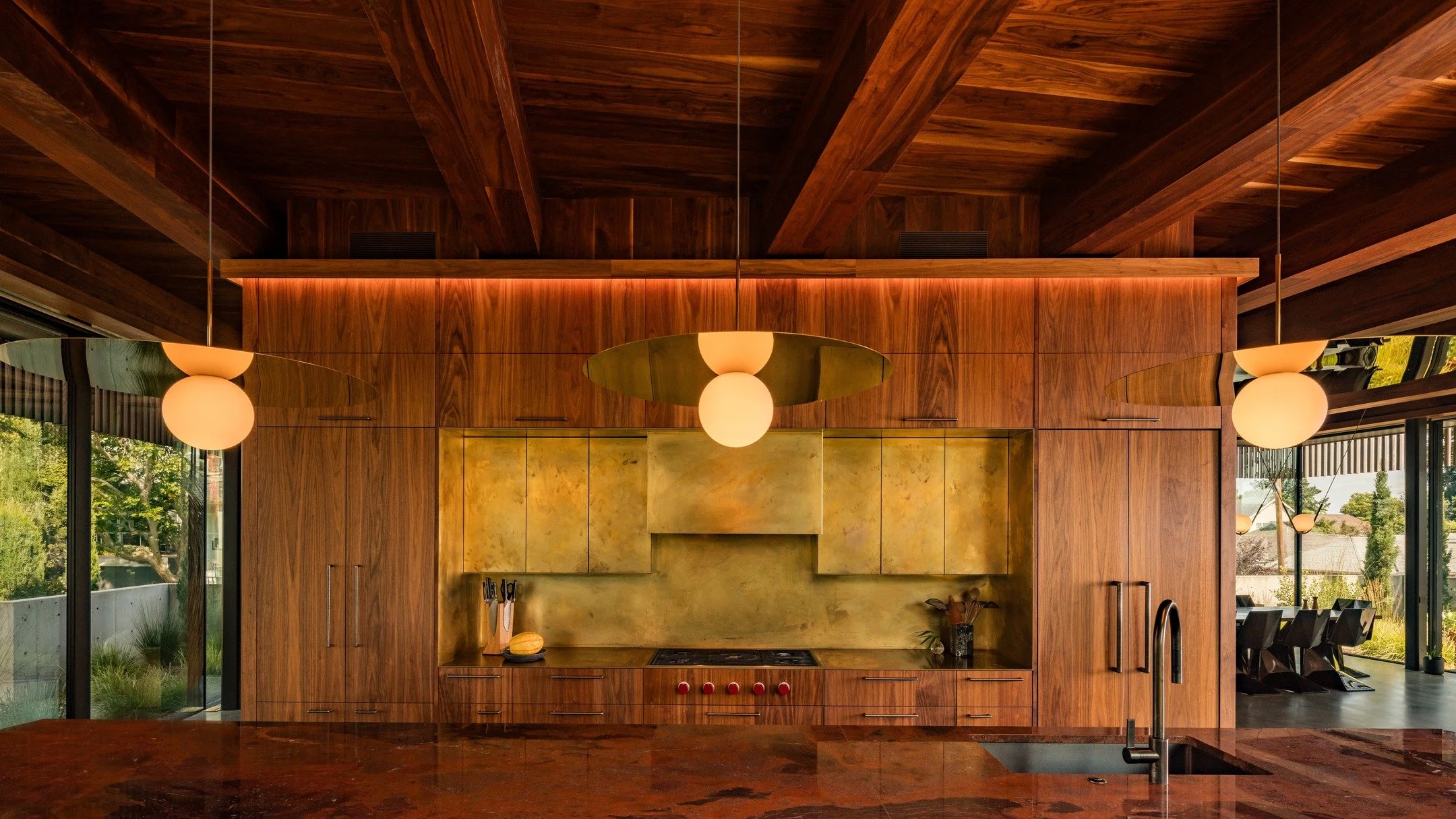 Some more angles from the epic #trilogyhousepdx project. The brass on the inset portion of the kitchen is by @jordanhufnagel. We wrapped the beams and covered the ceiling of this entire level with walnut, a process that took weeks and felt like our v