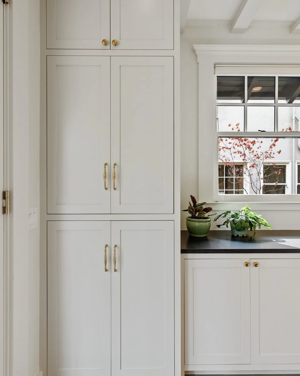 Unique storage possibilities abound in this kitchen designed by our own @bren.resisted and @meghann.reis for unique clients: Bren's parents! Laundry machine alcoves, an appliance garage, custom panel appliance fronts, reeded glass doors, a drawer ban