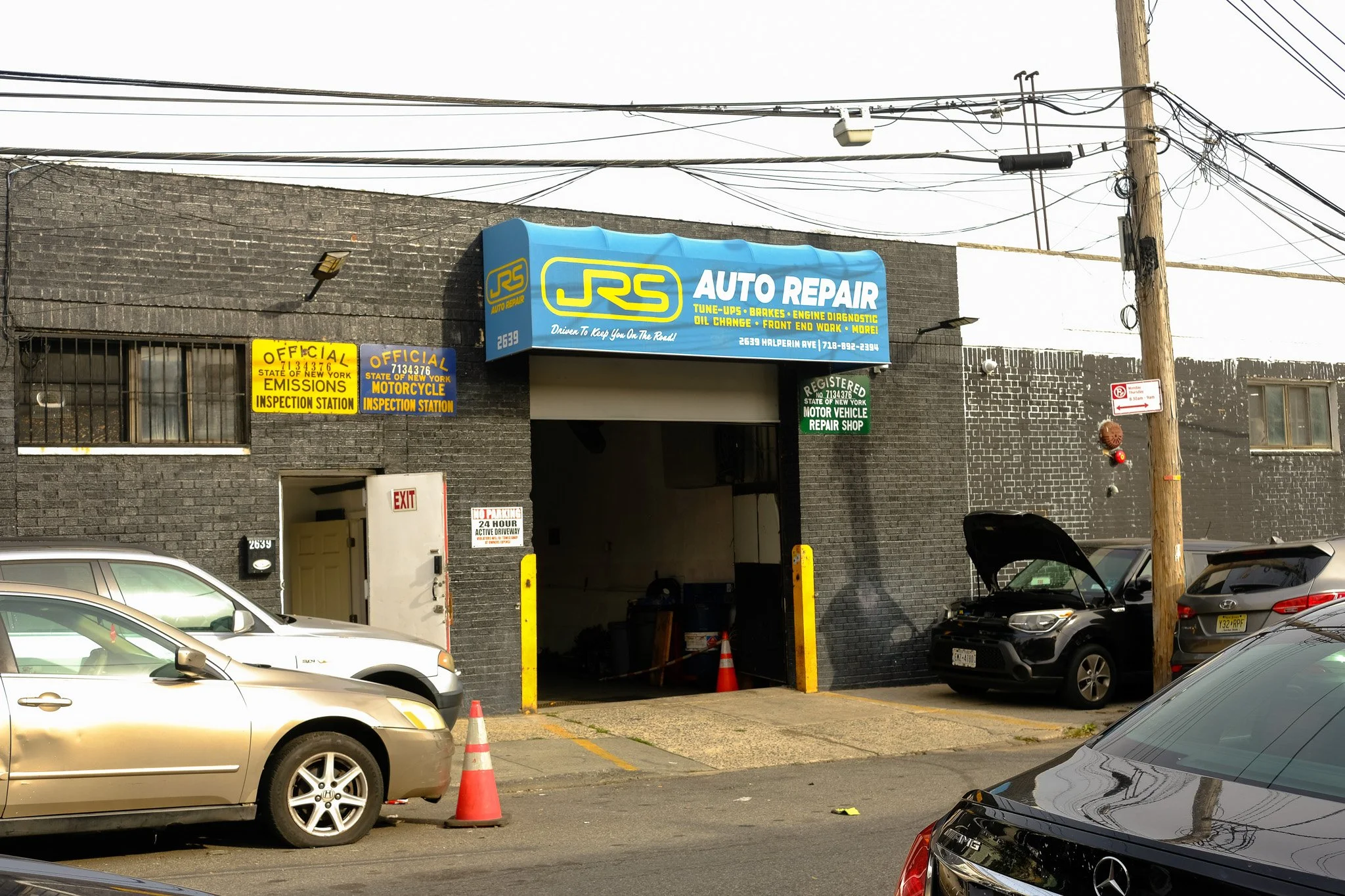front of JRS Auto Repair shop with blue awning