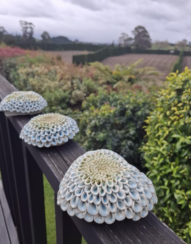 Blue and green set of 3 dahlias on rail.png