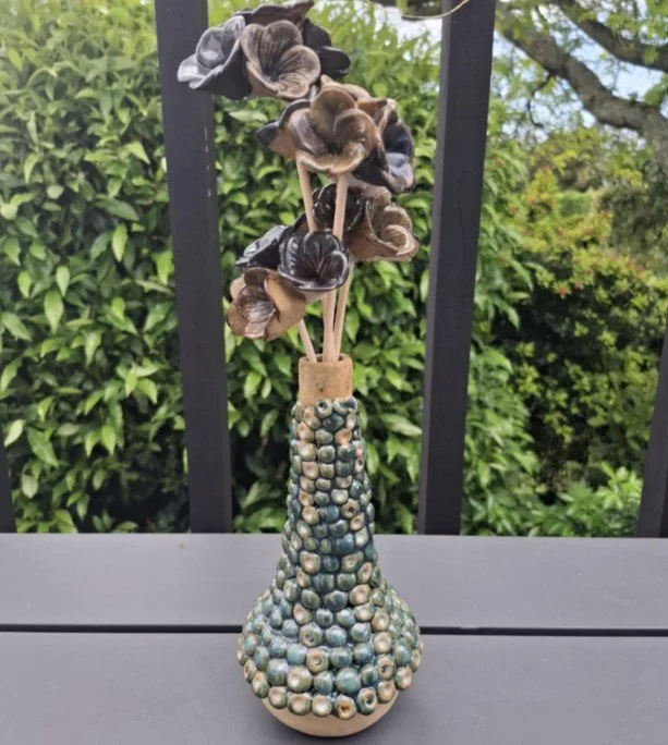 Bobble vase with ceramic flowers.jpg